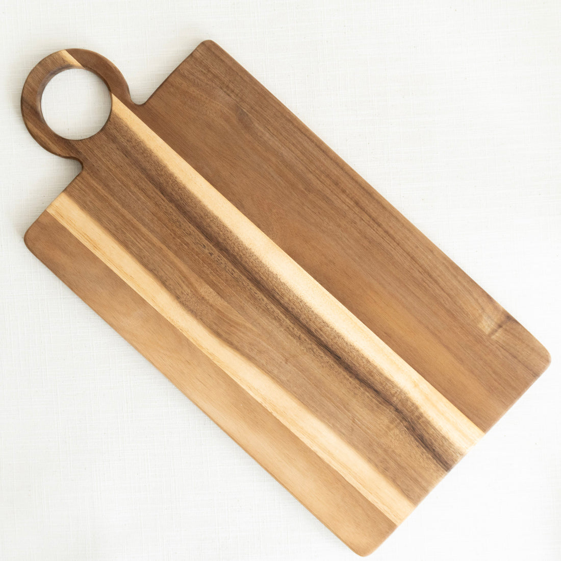 Wooden cutting board with a handle on a white background