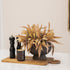 Decorative fall kitchen bundle with a plant, candles, and a cutting board on a white surface.